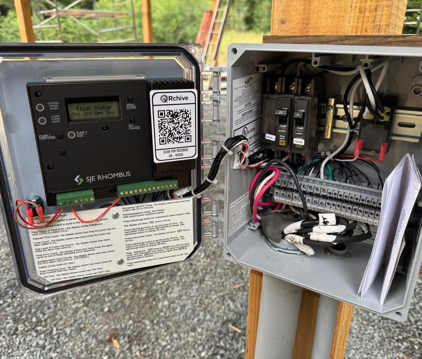 The QRchive sticker on the demo archive’s SJE Rhombus pump-control panel, outdoors on site